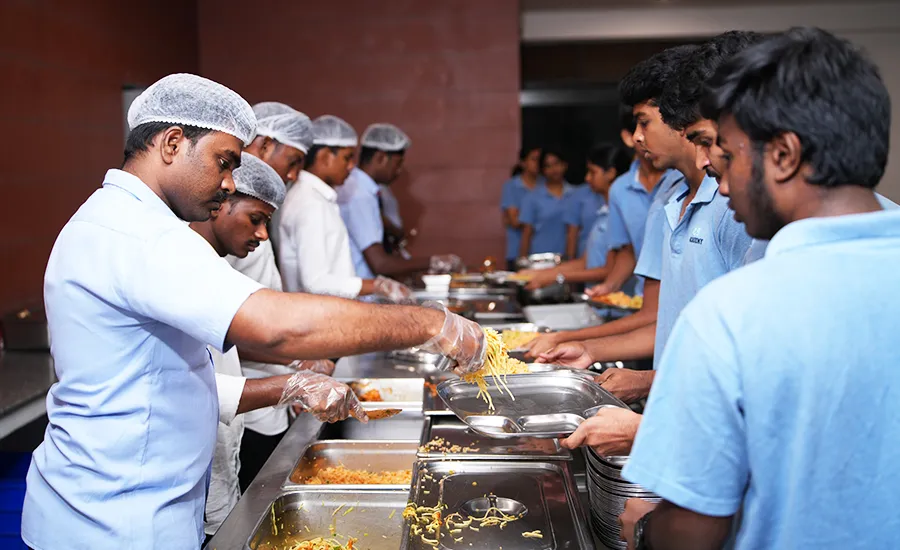 Industrial catering staff serving fresh vegetarian meals by Iyer Caterers in Bangalore during a large-scale event.